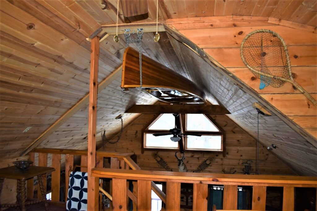 Canoe hanging from ceiling of shady oaks cabin